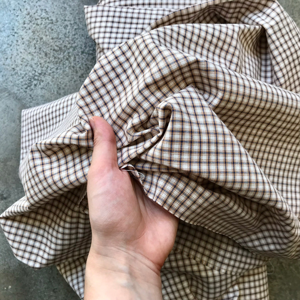 A folded piece of brown and beige gingham fabric