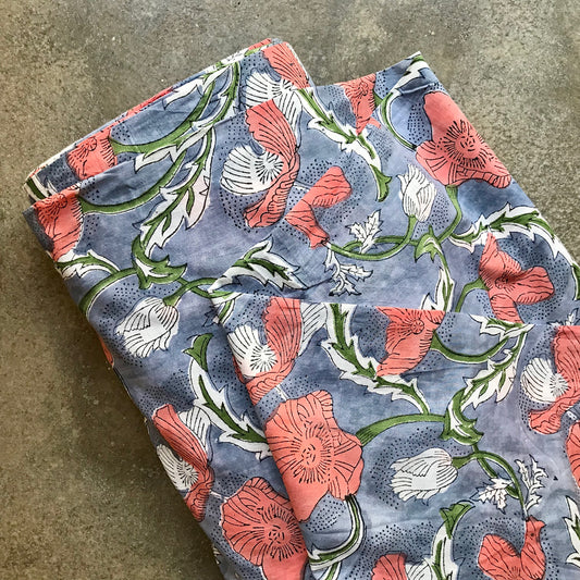 Indienne 4936224 Floral patterned fabric with pink and white flowers on a blue background