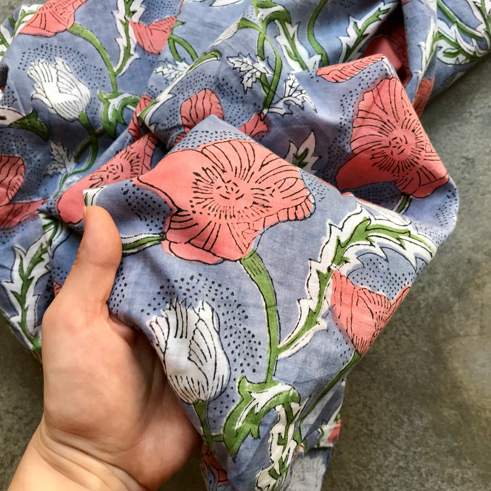 Indienne 4936224 Floral patterned fabric with pink and white flowers on a blue background