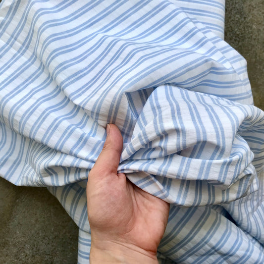 Cortijo: a light blue and white striped fabric