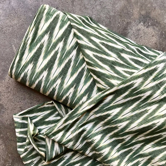 Ikat 4724124 Green and white striped fabric on a textured surface