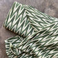 Ikat 4724124 Green and white striped fabric on a textured surface