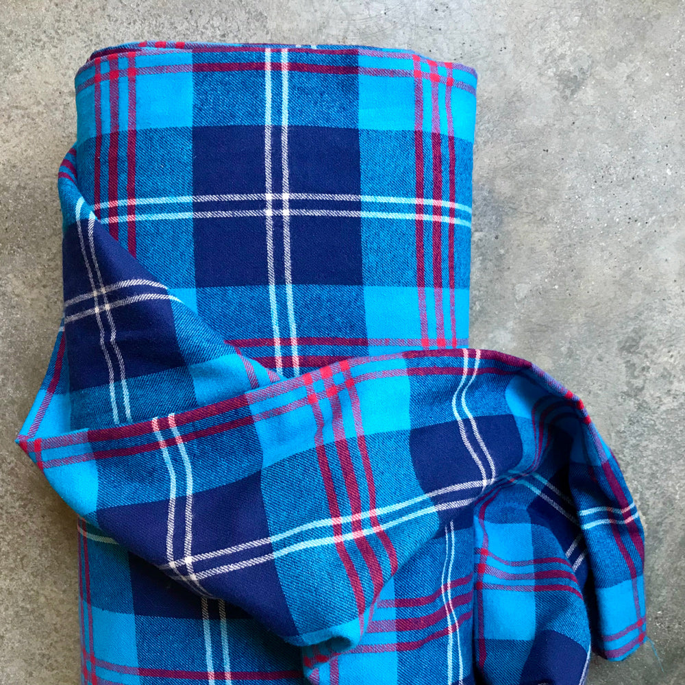 Tartan 41058521 -  blue plaid fabric with red and white lines on a gray surface