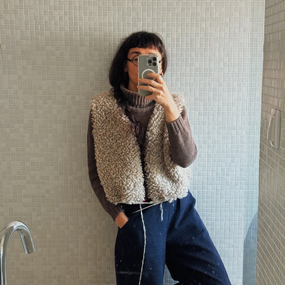 Samarra vest in size 3. Person wearing a textured handknitted wool vest taking a mirror selfie.