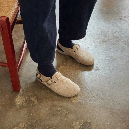 Person wearing wool felt clogs / sandals
